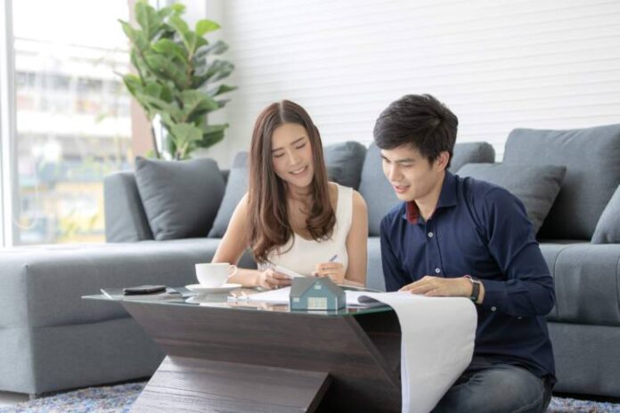 Asian,Teenage,Couple,Planning,To,Buy,And,Build,His,Future