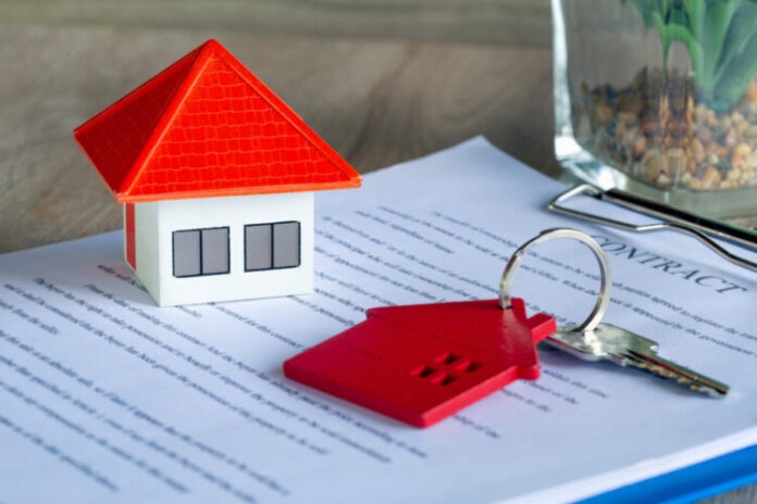 Orange,House,And,Red,Key,Ring,Placed,On,Home,Purchase